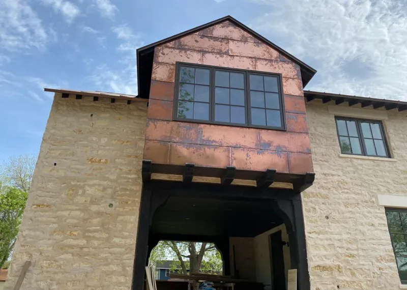 Copper metal panel facade on a stone building for Skylight Installation in Oakwood